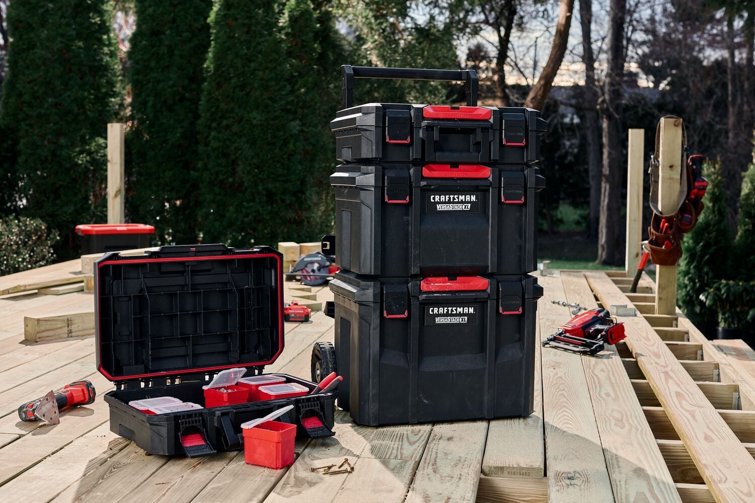 Craftsman stackable tool boxes with red accents, SKU CMST21430, shown on a wood deck with tools.
