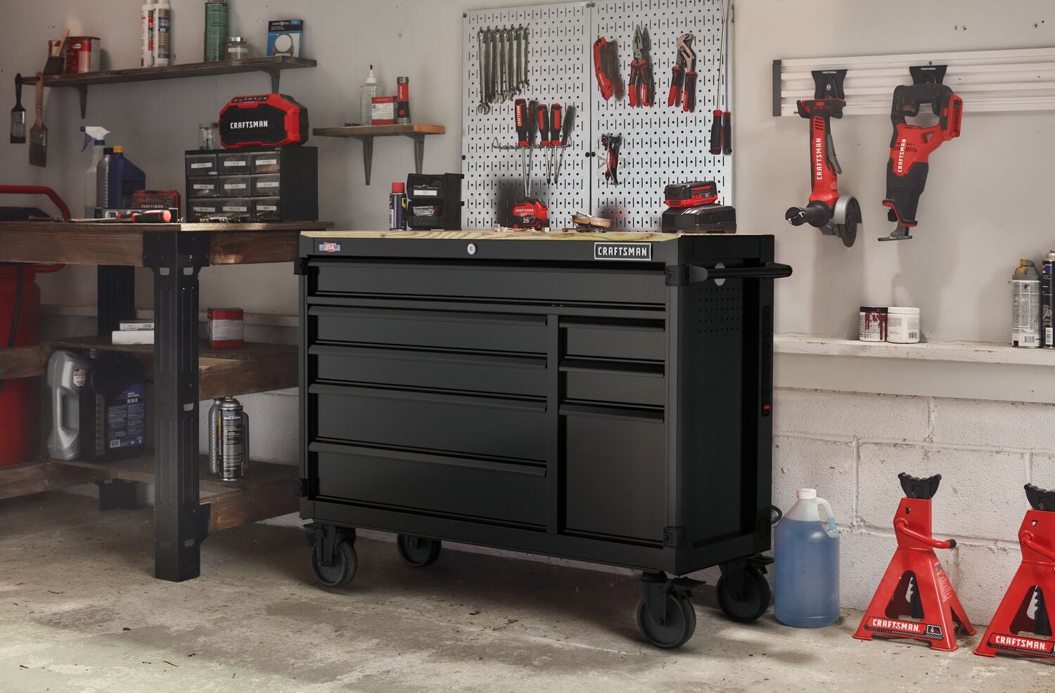 Photo of Craftsman black rolling tool chest CMST98274BK in a garage workshop setting with tools nearby.