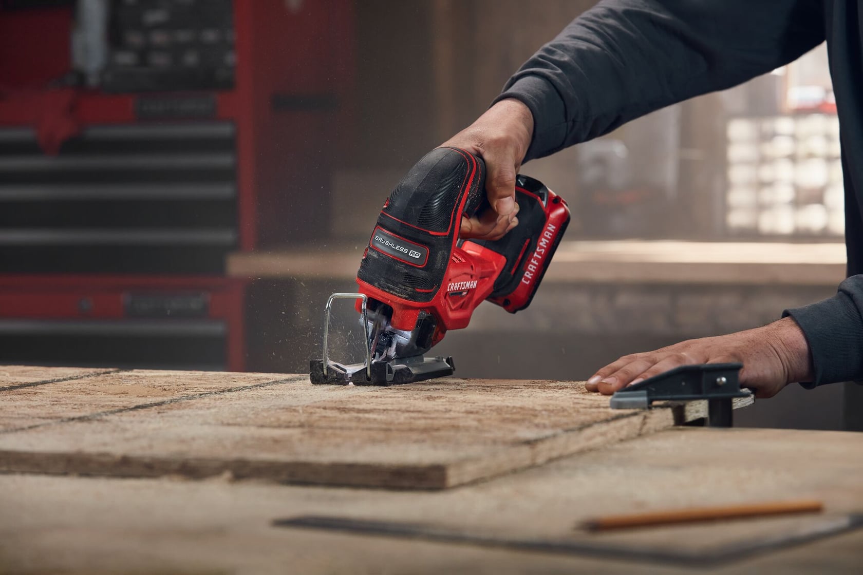 Photo of Craftsman cordless jigsaw CMCS650B cutting wood, close-up view in workshop setting.