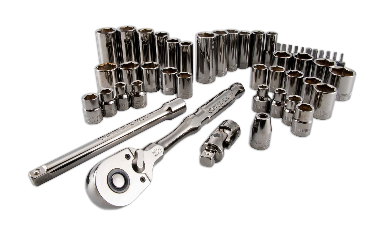 A set of metal socket wrenches and related attachments arranged on a white background. The set includes various sizes of sockets, a ratchet handle, an extension bar, and other accessories used for mechanical work.