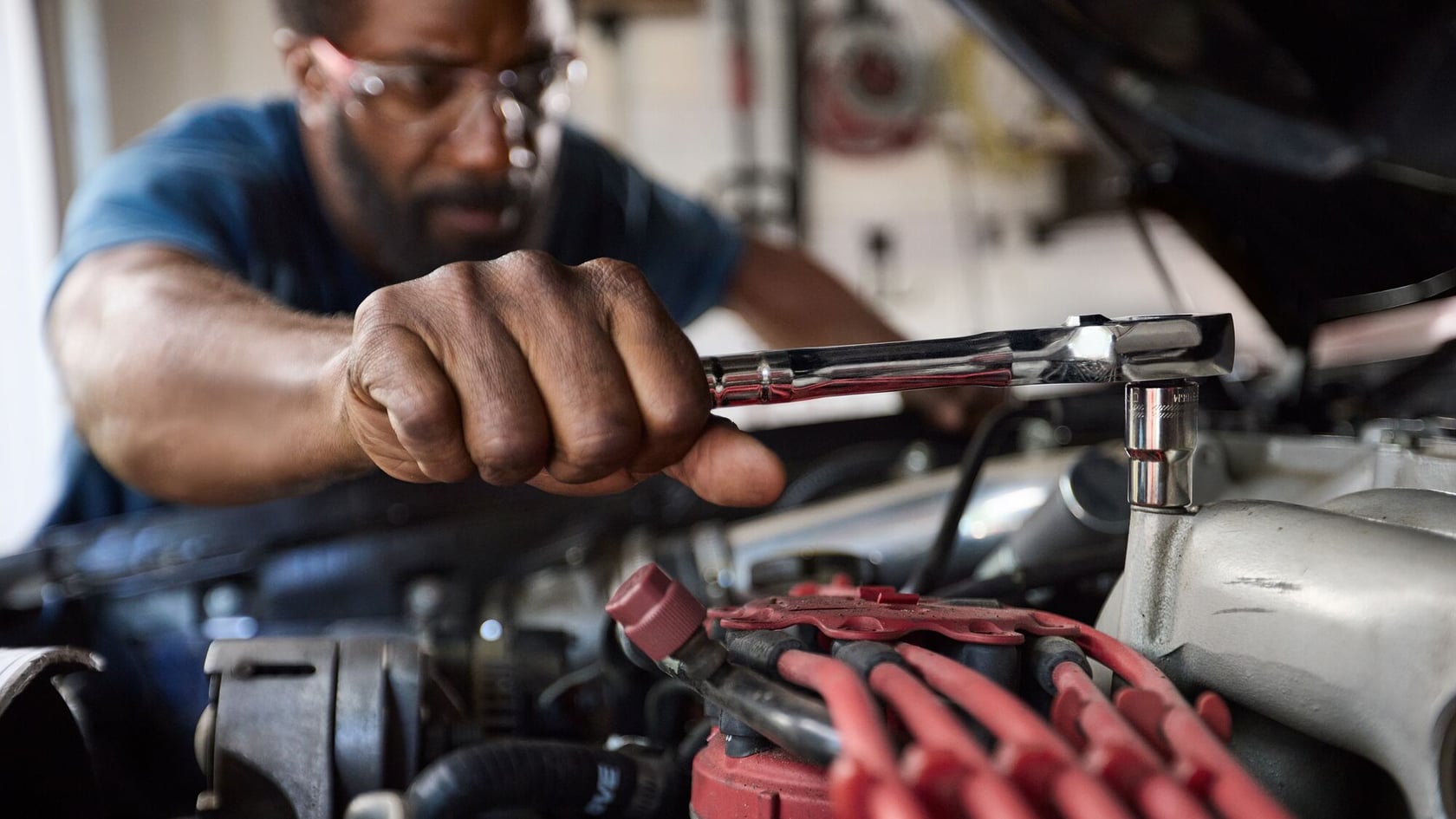 Photo of CRAFTSMAN ratchet wrench being used on a car engine, close-up, BrandWebsites SKU not visible.