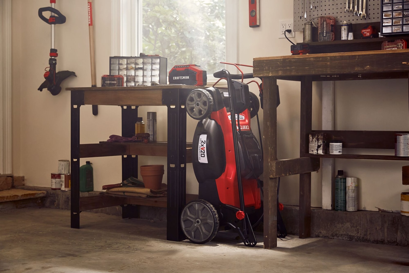 20 inch brushless cordless self propelled mower kit placed in storage room.