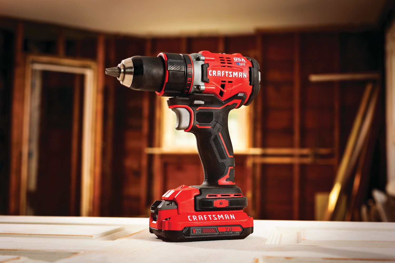 Cordless brushless half inch drill and driver kit 2 batteries placed on construction site.