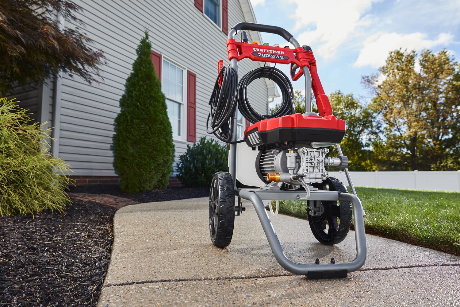 CRAFTSMAN 2800 Pressure Washer sitting on sidewalk with home in background