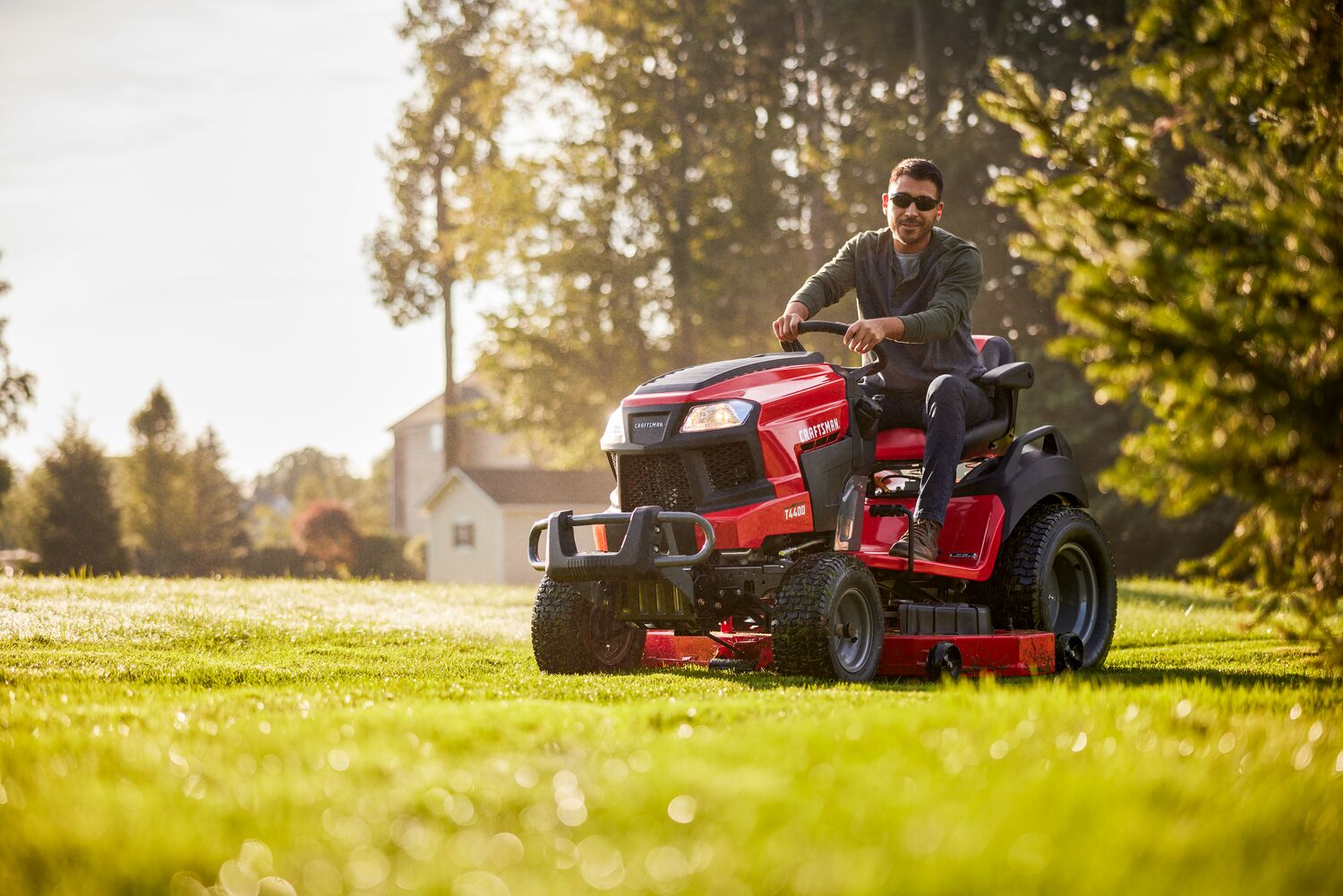 Side angle view of male riding T4400 Tractor