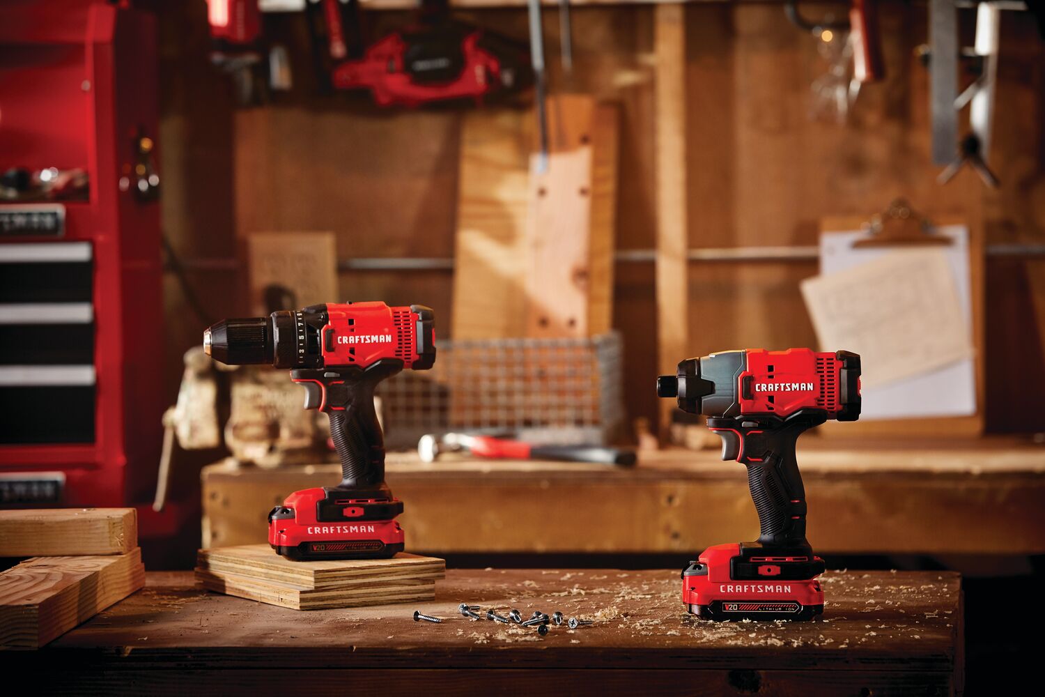 Cordless 2 tool combo kit with 2 batteries placed on the table with screws and wood pieces.