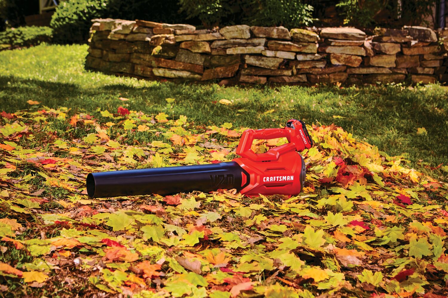 Cordless axial leaf blower kit 2 amp hour placed in lawn.