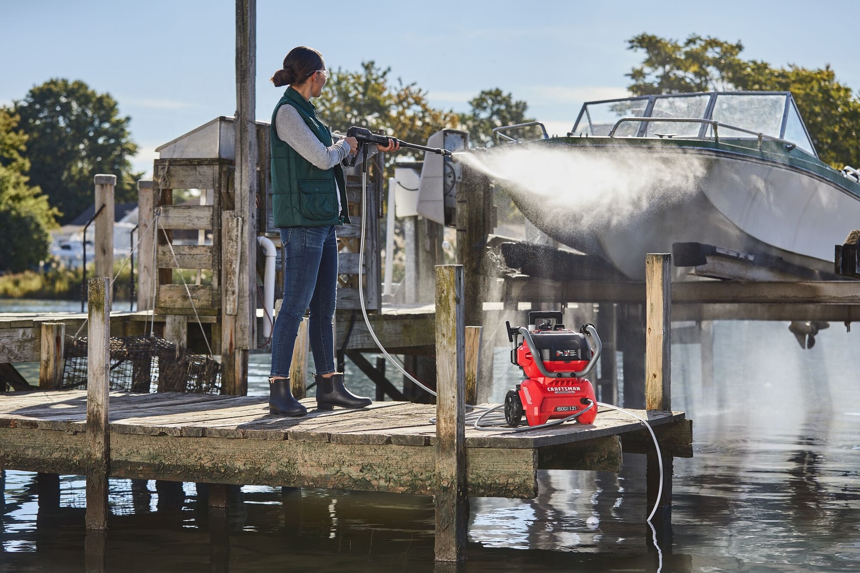 CRAFTSMAN 1500 PSI Pressure Washer washing a raised boat at pier