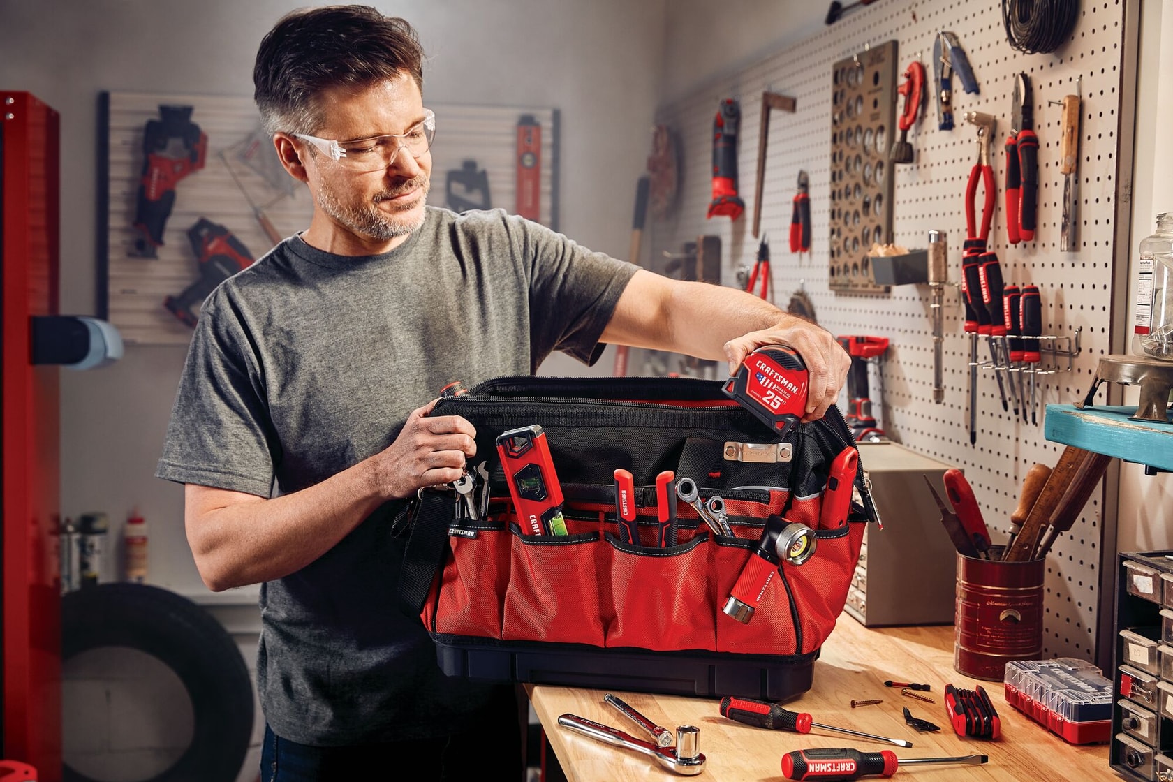 Versastack 17 inch tool bag being used by a person to store items.