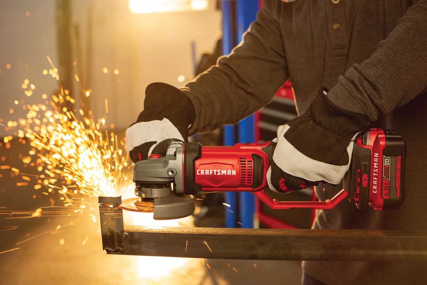 Cordless 4 and half inch small angle grinder kit 1 battery being used to cut tough material.